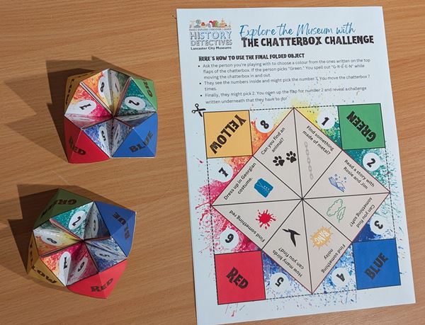 Photo of a 'Chatterbox' - colourful folded paper device containing various challenges for children to complete around the museum.
