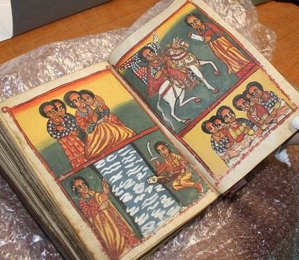 photo of an open book displaying a double page of colourful illustrations