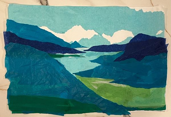 photo of a torn paper collage depicting a landscape of hills and a river