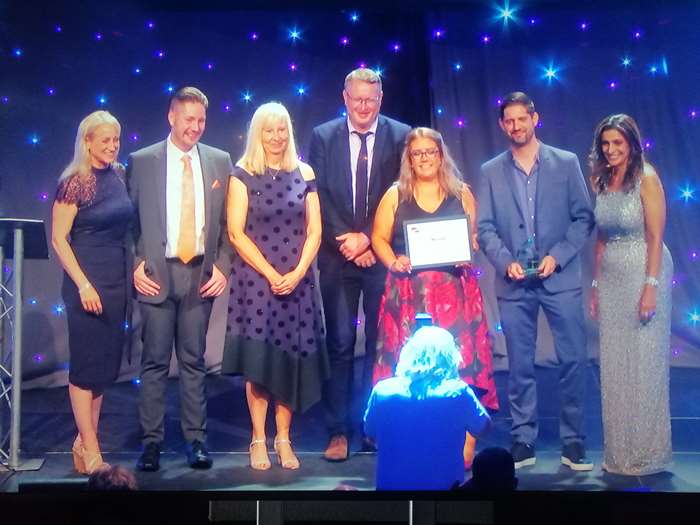 Delegates from Lancaster City Council receive the award for ‘Best service team – housing, construction and building service’ from the host of the awards, Sameena Ali-Khan.