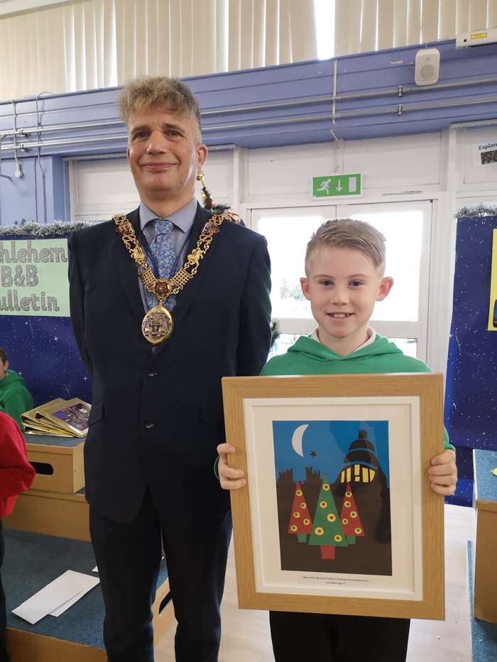 Leo Robson receives a framed copy of his winning design from the mayor