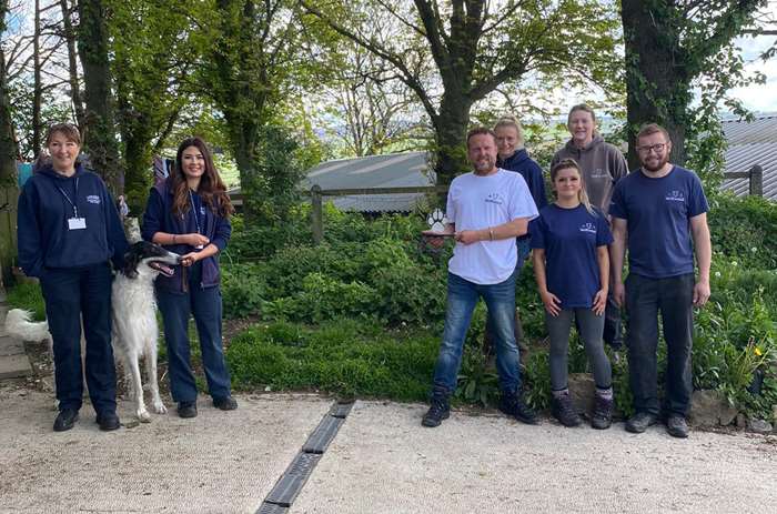 Sarah Hayland and Sarah Jones, from Lancaster City Council's dog warden and animal licensing team, presenting the award to the team from Wolfwood Wildlife and Dog Rescue.